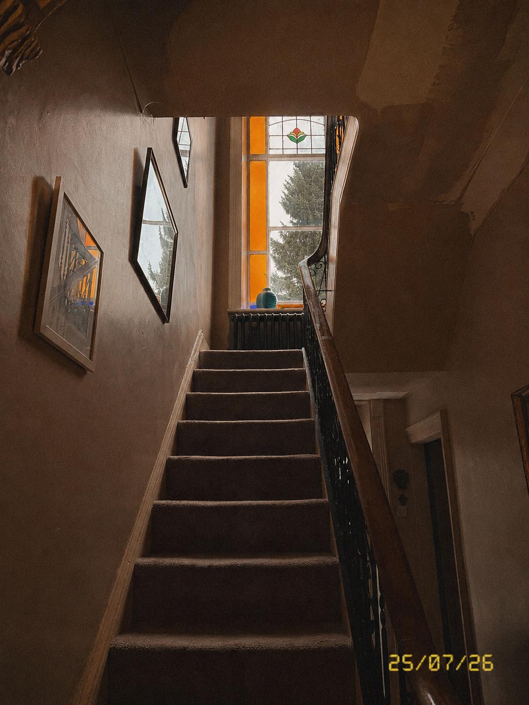 Original staircase with stained glass landing window