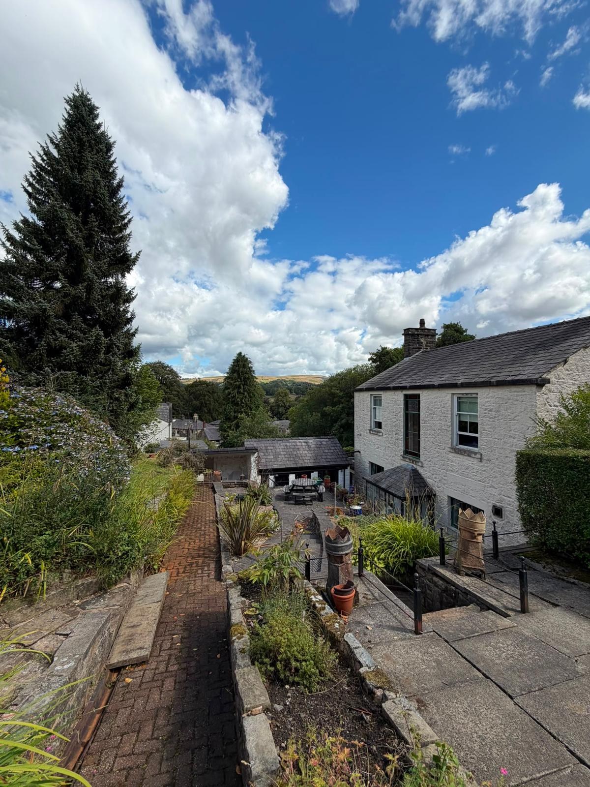 Brick path and dry stone terraces looking out over Ramsbottom rooftops