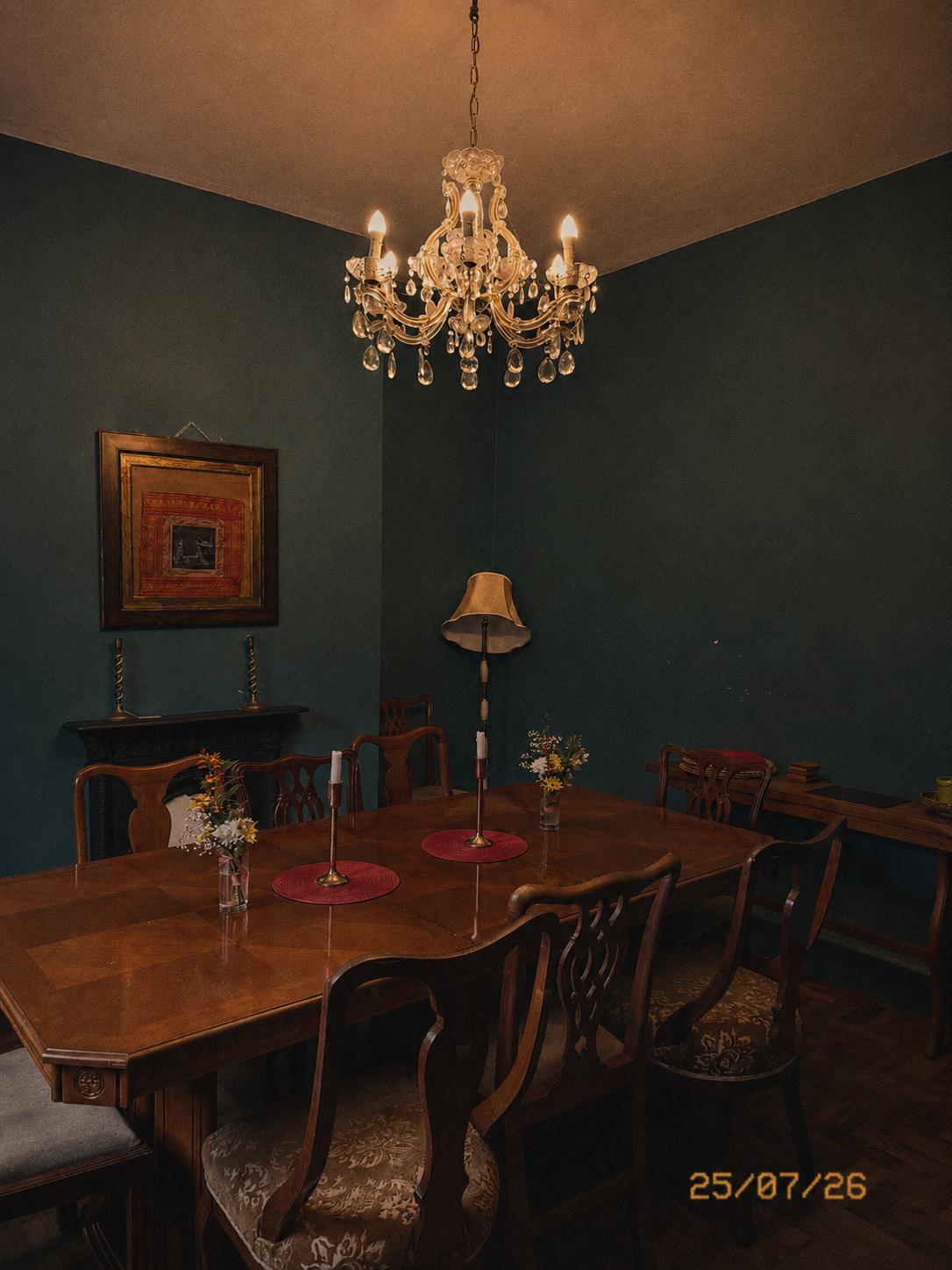 Dining room with a chandelier and dark green walls
