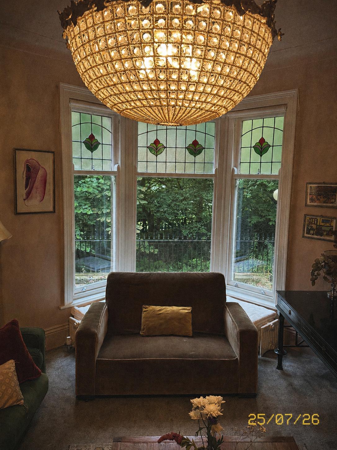 Sitting room with stained glass bay window and crystal chandelier